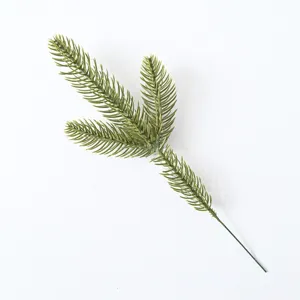 Detailed close-up of a realistic green artificial pine branch for DIY Christmas wreaths