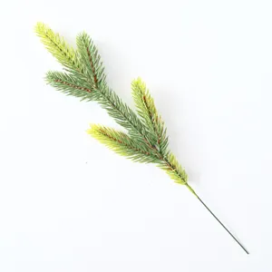 Close-up detail of realistic artificial green pine branch with yellow tips for DIY wreaths
