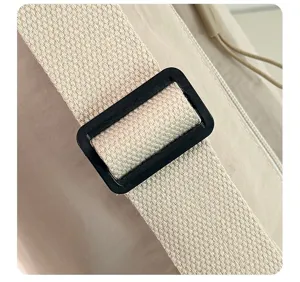 Primo piano del cinturino in nylon della borsa a tracolla con fibbia nera regolabile.