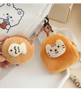 Close-up of cute plush fish and cat coin purses showing soft texture and zipper detail