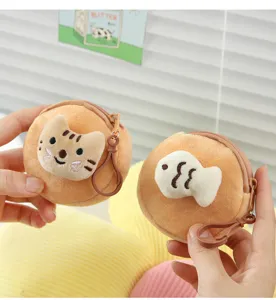 Detail view of two soft plush coin purses with cute cat and fish embroidery and hooks