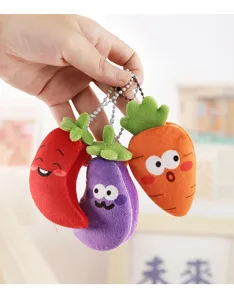 Close-up detail of cute plush vegetable keychains, featuring chilli, eggplant and carrot designs.
