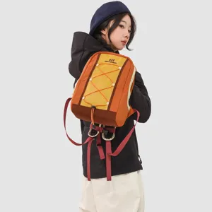 Detail showing the multi-color hiking backpack worn by a model in a studio setting.