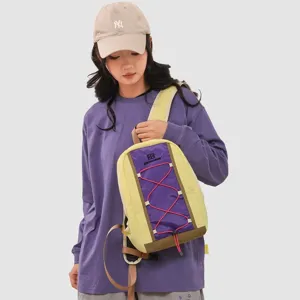 Detailed view of a yellow and purple outdoor hiking backpack worn by an Asian model