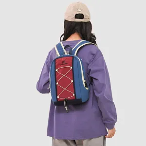 Back view of a woman wearing a blue and red hiking backpack with reflective strips