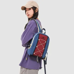 Outdoor hiking and running backpack in blue and red colorway worn by female model