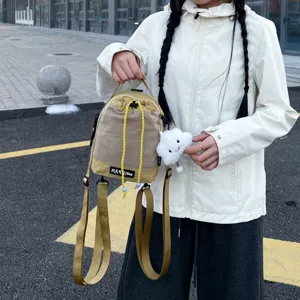 Compact casual drawstring small backpack and shoulder bag with cute cloud pendant for daily use.