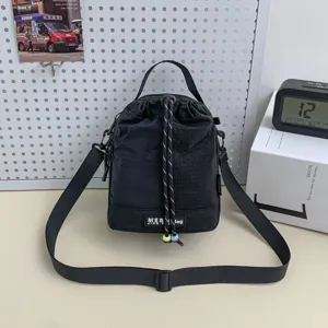 Black nylon bucket crossbody shoulder bag with drawstring closure and adjustable strap for daily use