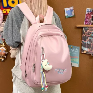 Sac à dos décontracté rose élégant pour femmes et étudiants avec grande capacité et pendentif lune.