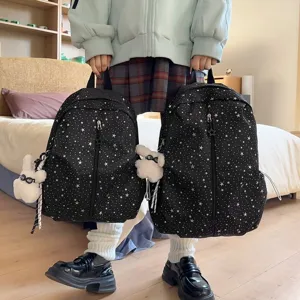 Juego de dos mochilas negras con patrón de estrellas blancas para la escuela y viajes