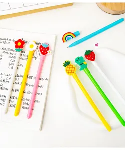 Close-up of cute cartoon gel pens with fruit and dinosaur silicone toppers