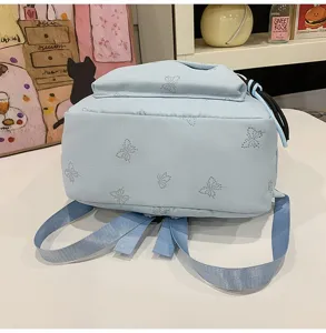 Detailed view of the light blue casual backpack featuring sparkling rhinestone butterfly patterns.