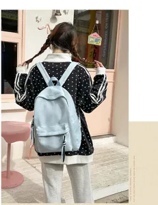 Light blue casual student backpack detail view, featuring cute butterfly pattern and roomy design.