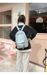 Casual light blue backpack for daily use, stylish simple design large capacity school bag for students.