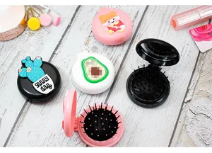 Macro view of portable folding cartoon hairbrush sets with mirrors on white wood