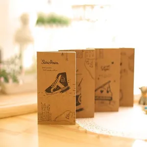 Portable kraft paper pocket notebook with creative illustration cover design for daily writing notes office.
