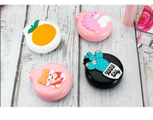 Collection of cute cartoon folding hairbrushes with built-in mirrors on wood background