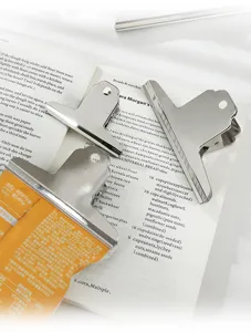 Close-up of stainless steel bulldog clips holding a snack bag for organized storage.