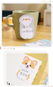 Close-up detail of cute penguin and corgi shaped cartoon sticky notes on everyday items