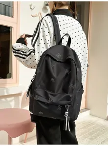Black casual backpack with rhinestone butterfly pattern, large capacity daily school bag for students.