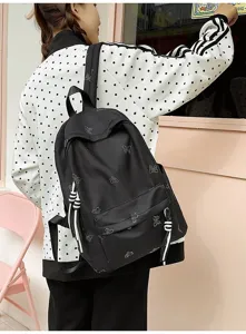 Detailed shot of a black canvas backpack featuring sparkling rhinestone butterfly patterns for daily use.