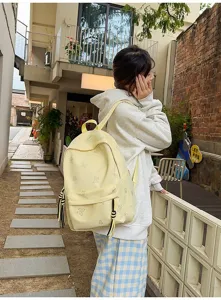 Casual light yellow school backpack with cute butterfly prints and tassel charms for daily.