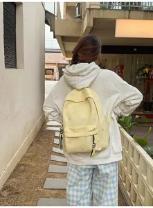 Casual yellow butterfly print backpack detail view, perfect for daily commuting and school.