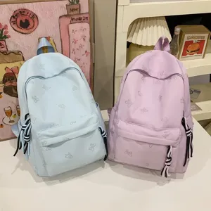 Casual student school backpacks in light blue and purple with cute butterfly patterns.
