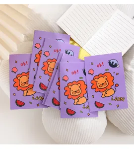 Detailed view of mini purple lion notebooks showing lined pages and cartoon cover
