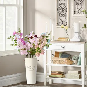 Artificial flower arrangement in metal bucket home decor for living room table.