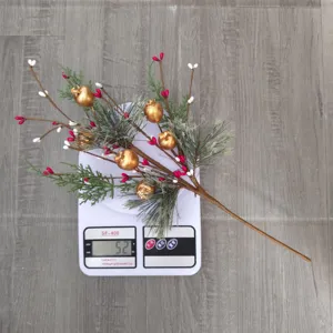 Artificial Christmas pine branch with golden pomegranates, weight 52g on scale
