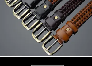 Close-up detail of hand-woven leather belts in black and brown with vintage pin buckles