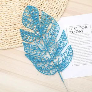 Blue glitter artificial monstera leaf detail shot, perfect for floral arrangement decor.