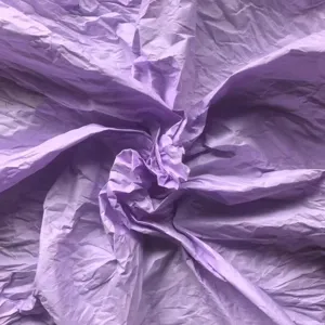 Detailed macro view showing the unique crumpled texture of purple hand-rubbed wrapping paper