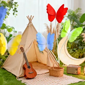 Outdoor camping scene detail with large colorful gradient felt butterfly decorations and cute props.