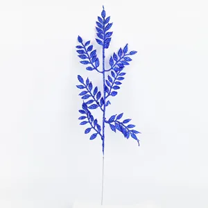 Blue glitter artificial plant branch detail, sparkling foliage prop for home and festival decor.