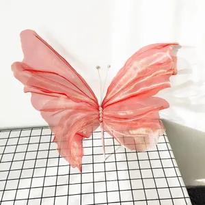 Detailed view of a large pink decorative gauze butterfly with shimmering gold accents.