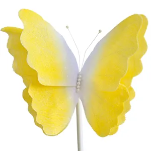 Detailed view of the yellow gradient felt butterfly decoration with delicate pearl accents and stick.