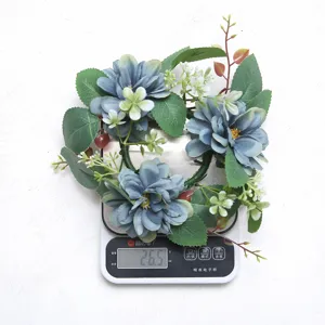 Detailed macro view showing the 26.5g weight of a blue artificial dahlia candle ring wreath