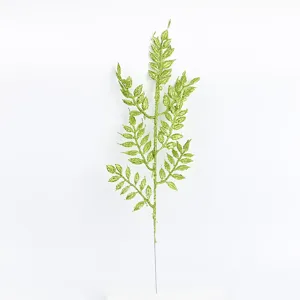 Close-up of green glitter artificial leaf branch, perfect for Christmas and wedding decor details.