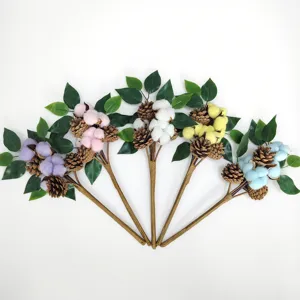 Colorful artificial cotton flower branch detail display featuring pinecones and green leaves.