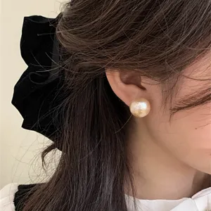 Large vintage cotton pearl stud earrings shown as worn by model in an elegant French style