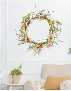 Artificial Easter wreath with colorful pastel eggs and berries for festive spring wall decoration