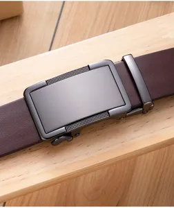 Close-up of men's brown leather belt with matte black automatic buckle for business.