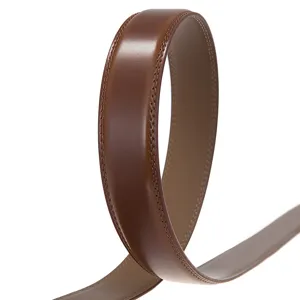Detailed macro view of a premium brown leather belt strap with refined stitching