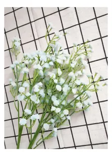 Primer plano de flores artificiales de velo de novia, rama azul claro de goma suave para decoración.