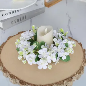 Couronne de bougie florale blanche avec base en bois et bougie LED pour décoration de table.
