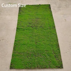 Full view of rectangular artificial green moss turf roll on plain floor background