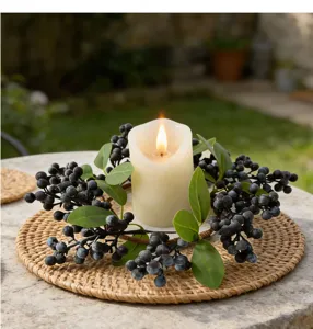 Detailed shot of an artificial black berry candle ring wreath for Nordic home decor
