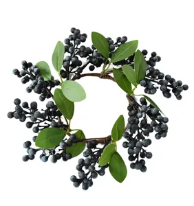 High-quality detail of artificial blueberry wreath with green leaves for festive home decor